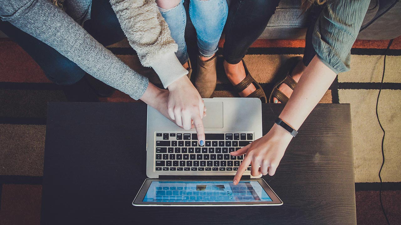 Mehrere Personen zeigen mit augestrecktem Finger auf einen Laptop-Bildschirm © John Schnobrich - Unsplash